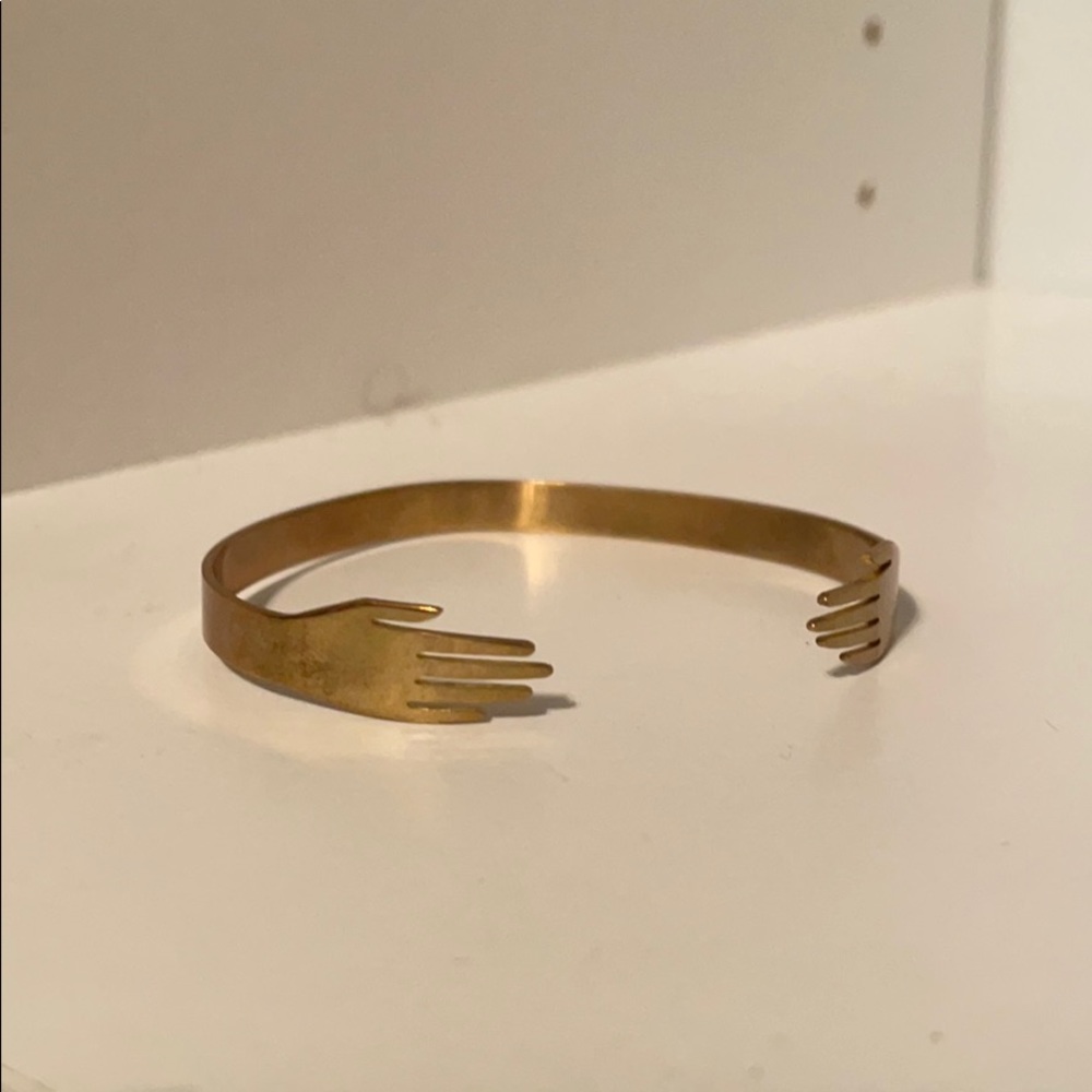 Two hands touching adjustable bangle